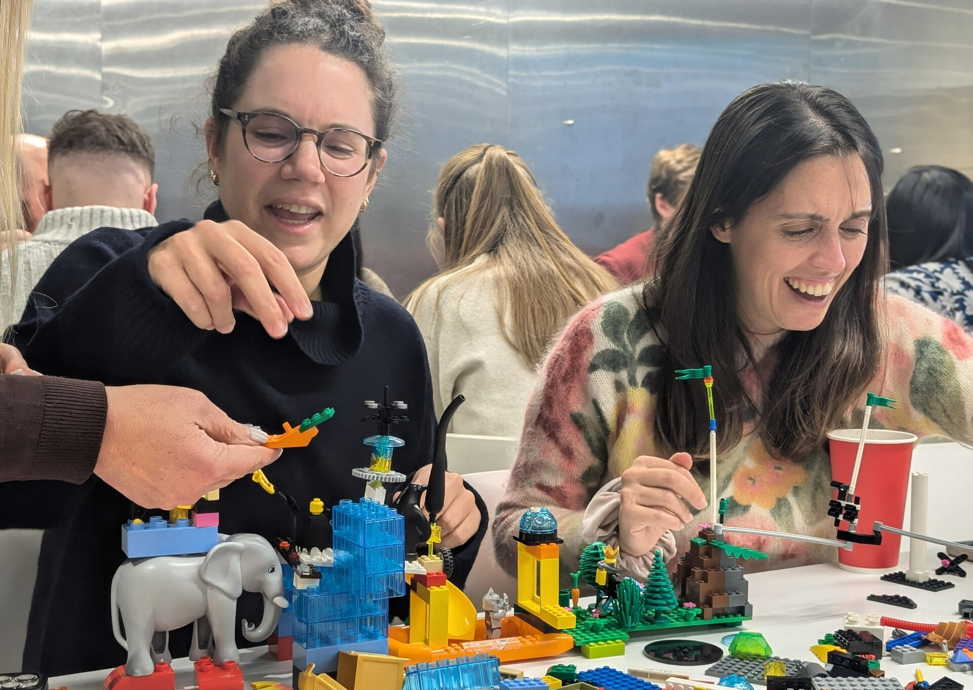 Women laughing with LEGO Serious Play at Climate Play workshop